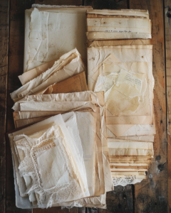 tea dyed vintage journal papers drying on rustic wooden surfa dd0408e8 8f71 45ee 8beb 34a2a7844499 2